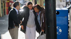 Leticia Harris, center, whose husband Sergio Harris was killed in the mass shooting in downtown Sacramento early Sunday, speaks with a police detective, left, while his mother Pamela Harris sobs.