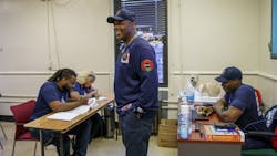 Chicago Fire Department Lt. Quention Curtis with students at the Black Fire Brigade in the Washington Park neighborhood on April 7, 2022, in Chicago. Chicago Fire Department Lt. Quention Curtis with students at the Black Fire Brigade in the Washington Park neighborhood on April 7, 2022, in Chicago.