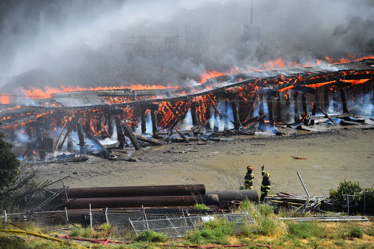 Firefighters work to extinguish a fire at the Port of Benicia in Benicia on Saturday.