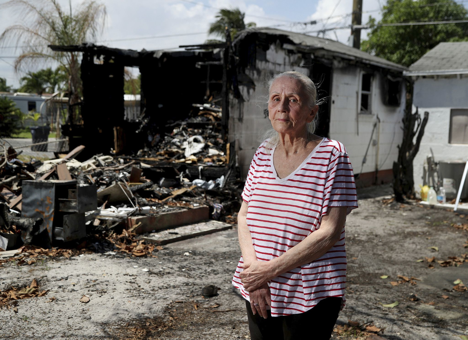 Judith Garwood stands in front of her Hollywood home that went up in flames on April 10.