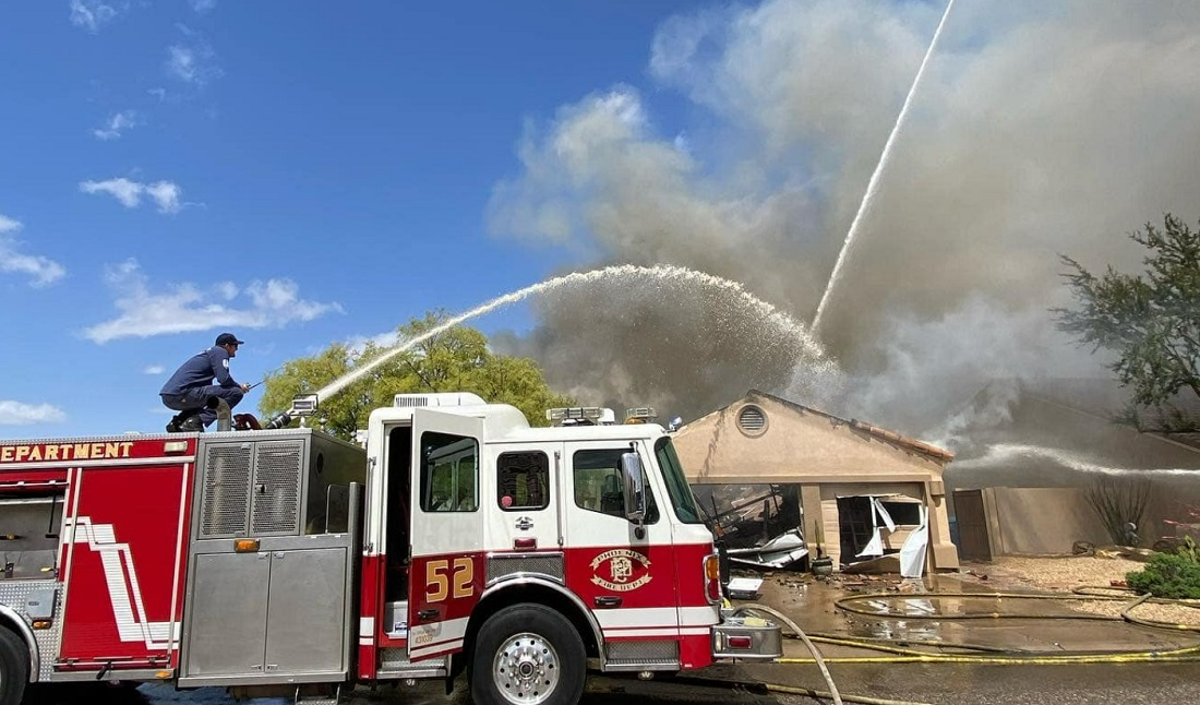 A Phoenix firefighter was trapped and safely rescued by fellow firefighters after a partial roof collapse at a dwelling fire.