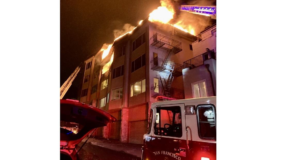San Francisco firefighters rescued two occupants during a two-alarm apartment fire that sent one firefighter to the hospital with burns.