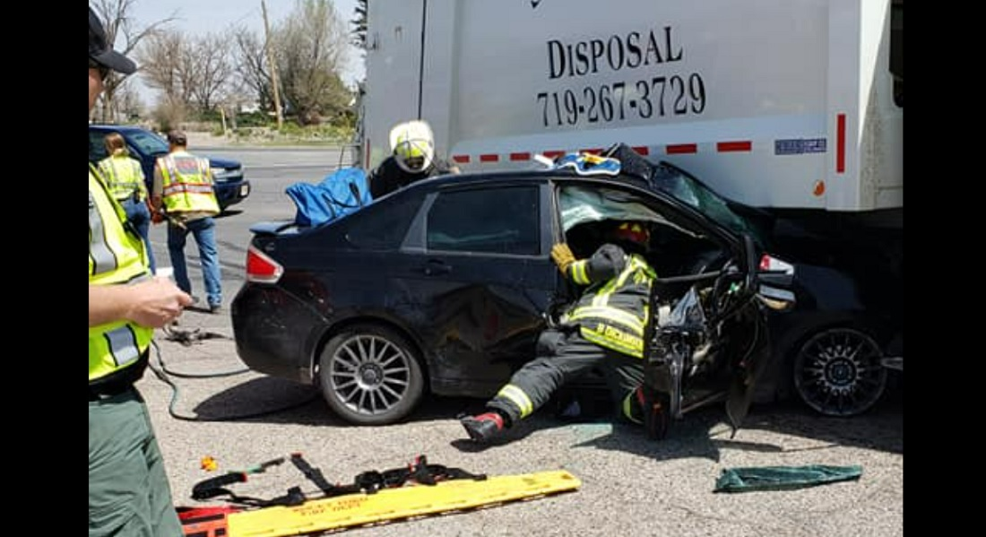 Rocky Ford firefighter had to extricate a man after his sedan became trapped under a refuse truck.
