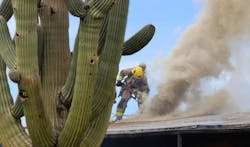 Tucson and Rural Metro fire crews battle a brush fire that extended into a dwelling.