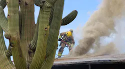 Tucson and Rural Metro fire crews battle a brush fire that extended into a dwelling.
