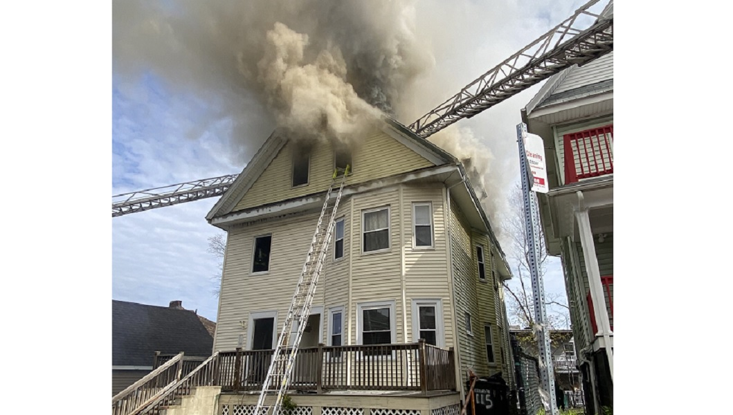 Boston firefighters battle flames in a 2 1/2 story dwelling that sent 2 children and 2 adults to the hospital and displaced 17 people.