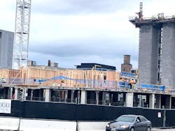 The unique facets of the construction of a building that has a 'podium' on bottom and a wood-frame structure on top include the fact that building systems traverse through a horizontal separation. The unique facets of the construction of a building that has a 'podium' on bottom and a wood-frame structure on top include the fact that building systems traverse through a horizontal separation.