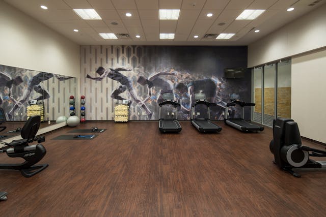 It&rsquo;s important to protect walls from dings as well as floors from scratches and dents. This physical conditioning space&rsquo;s commercial-grade vinyl floor tile and Type III wallcovering provide the performance needs while, in combination with large-scale graphics and wood-look patterns, creating a room that ignites energy and engagement.