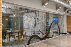 A simple black vinyl graphic of the map of the department’s city was installed on the interior of meeting spaces just off of the common corridor. Inside, the meeting spaces are simple: meeting tables and eye-catching industrial brass chairs, the latter giving a nod to the classic polished-brass fire pole. Pairing these touches with exposed round ductwork, wood-look wallcovering and a contrasting wall base bestows a contemporary design while maintaining durability and performance. A simple black vinyl graphic of the map of the department’s city was installed on the interior of meeting spaces just off of the common corridor. Inside, the meeting spaces are simple: meeting tables and eye-catching industrial brass chairs, the latter giving a nod to the classic polished-brass fire pole. Pairing these touches with exposed round ductwork, wood-look wallcovering and a contrasting wall base bestows a contemporary design while maintaining durability and performance.