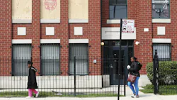 People walk by the apartment fire where a 3-year-old girl died early Saturday in Chicago. People walk by the apartment fire where a 3-year-old girl died early Saturday in Chicago.