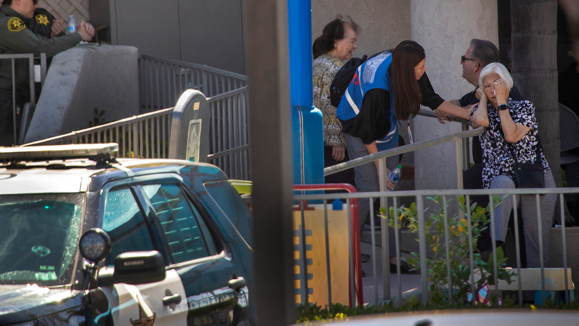 A grief counselor comforts a parishioner after a person opened fire during a church service, killing one person and critically injuring four others.