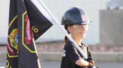 A recruit carries the Battalion 6 flag on the training grounds.