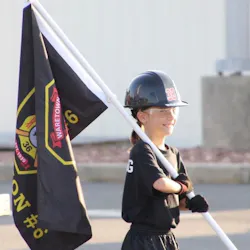 A recruit carries the Battalion 6 flag on the training grounds.