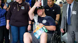 EMT Richard McMahon waves to supporters as he is released from Richmond University Medical Center in Staten Island Thursday.