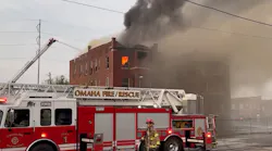 Omaha firefighters battle flames in a vacant apartment building recently closed by city officials.