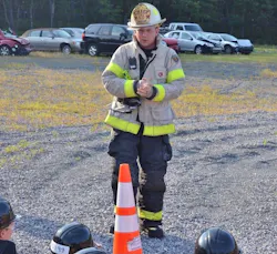 Chief Cunningham discussing fire behavior with the recruits during the live burn day.