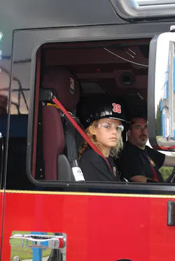 A recruit and Capt. Munt 'responding' to an assignment on Engine 3601. The recruits utilized the radios on the trucks to call en route and arrival at the scenes.
