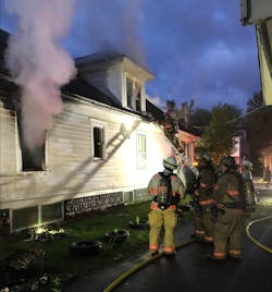 A Syracuse, New York firefighter vents the dormer windows at a vacant building fire Sunday night. A Syracuse, New York firefighter vents the dormer windows at a vacant building fire Sunday night.