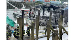 Seattle firefighters recovered the body of a man from one of three boats that were destroyed in fire at a Duwamish Waterway boathouse.