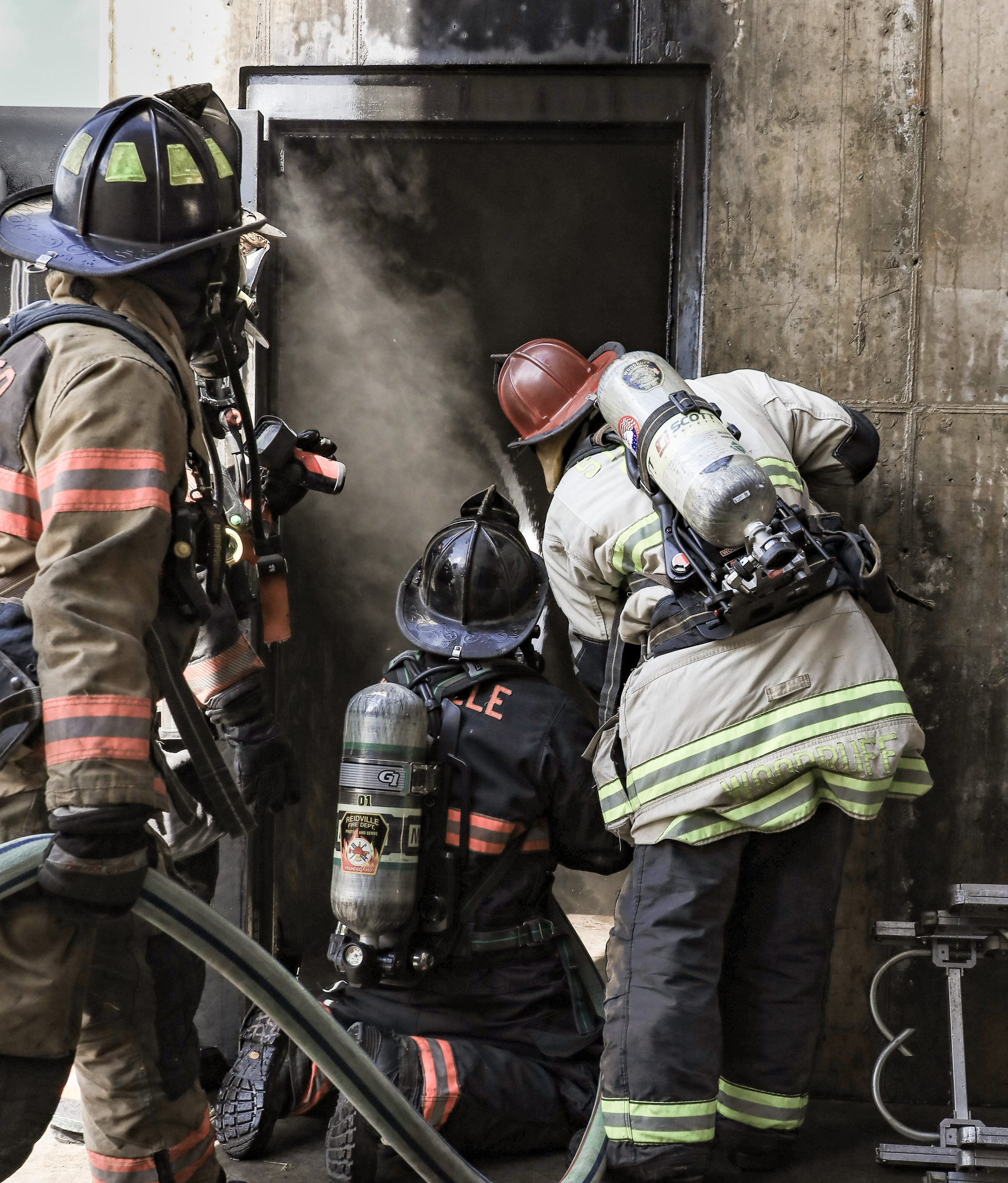 The hose crew of a minimally staffed department uses a thermal imaging camera at the entry door to flow water ahead toward the fire's room of origin.