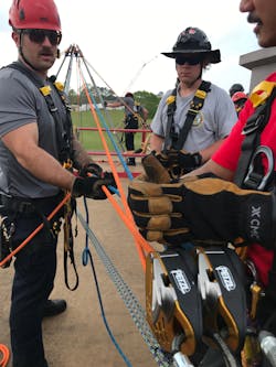 Rescuers utilize an operator and a rope tailer in the use of a dual main TTRS. The rigging pod must pass a critical point variance test and be suitably anchored to support both “halves” of the system. Rescuers utilize an operator and a rope tailer in the use of a dual main TTRS. The rigging pod must pass a critical point variance test and be suitably anchored to support both “halves” of the system.