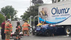 Firefighters work to extricate a patient trapped inside a car that collided with a truck in East Syracuse.