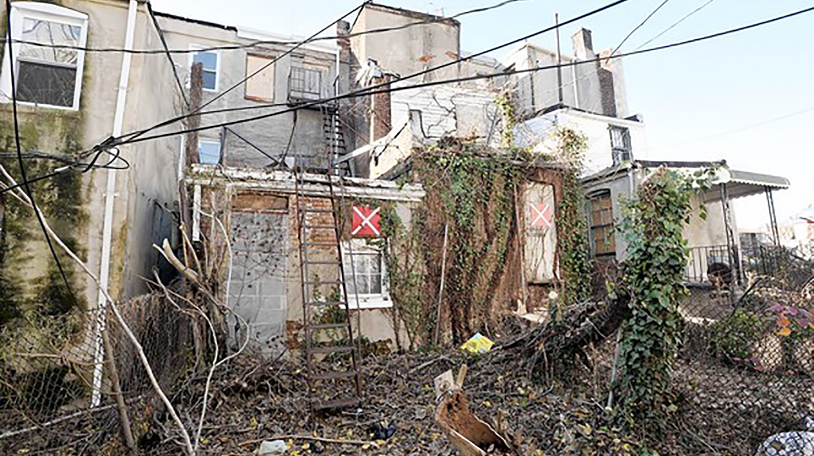 The rear of several vacant houses in Baltimore, shown in a file photo, that were marked with warning placards.