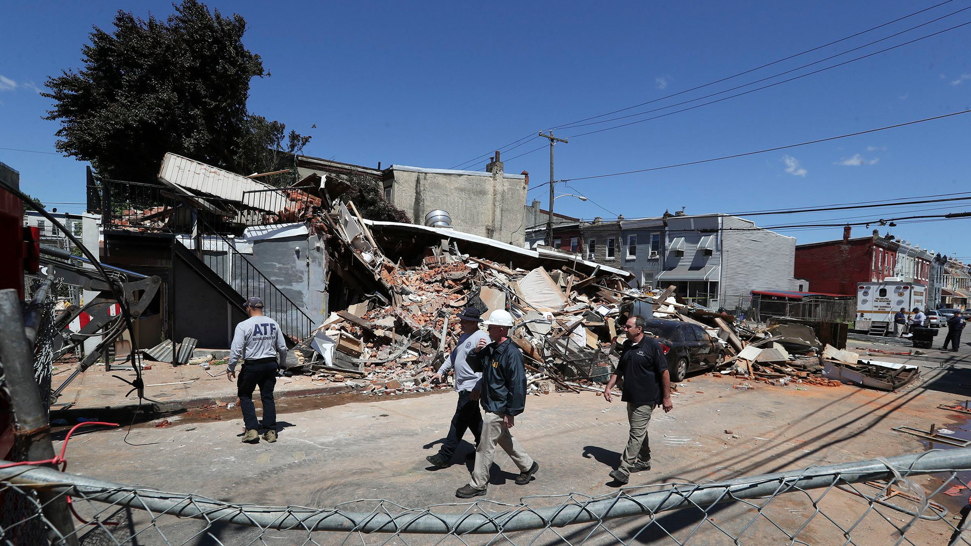 Investigators examine the remains of the collapsed building where Lt. Sean Williamson was killed and several firefighters and a building inspector were injured.