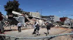 Investigators examine the remains of the collapsed building where Lt. Sean Williamson was killed and several firefighters and a building inspector were injured.