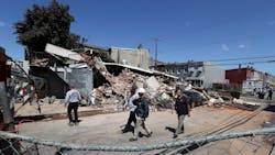 Investigators examine the remains of the collapsed building where Lt. Sean Williamson was killed and several firefighters and a building inspector were injured. Investigators examine the remains of the collapsed building where Lt. Sean Williamson was killed and several firefighters and a building inspector were injured.
