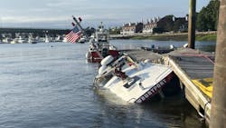 After listing to the side, the Newburyport Fire Department boat eventually sank to the bottom, sliding underneath a dock in the process. After listing to the side, the Newburyport Fire Department boat eventually sank to the bottom, sliding underneath a dock in the process.