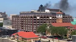 Dayton firefighters battled a fire on the roof of the former Delco plant building. Dayton firefighters battled a fire on the roof of the former Delco plant building.