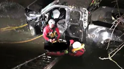 Syracuse firefighters donned wet suits and climbed down a ladder to rescue the two men after their truck went down a 20-foot embankment.