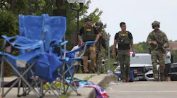 Law enforcement officers from multiple jurisdictions investigate the area in Highland Park on Monday, July 4, 2022.