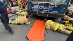 Stamford firefighters used airbags to lift the transit bus and rescue the woman and she was struck and trapped under the bus.