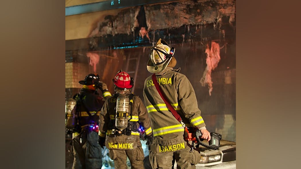The fireground commander, or FGC, (right) used a thermal imager (TIC) to confirm extension and the overhang from a car fire. He then ordered the exterior tear and the interior to be opened up more and water to be applied based on exterior use.