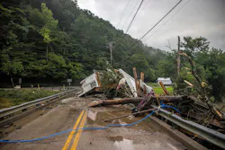 A house rests on a bridge near the Whitesburg Recycling Center in Letcher County, Ky., on Friday, July 29, 2022. A house rests on a bridge near the Whitesburg Recycling Center in Letcher County, Ky., on Friday, July 29, 2022.