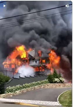 Screenshot of a video posted to YouTube by John Hammann of the $3.2 million mansion in Hingham, MA, going up in flames.