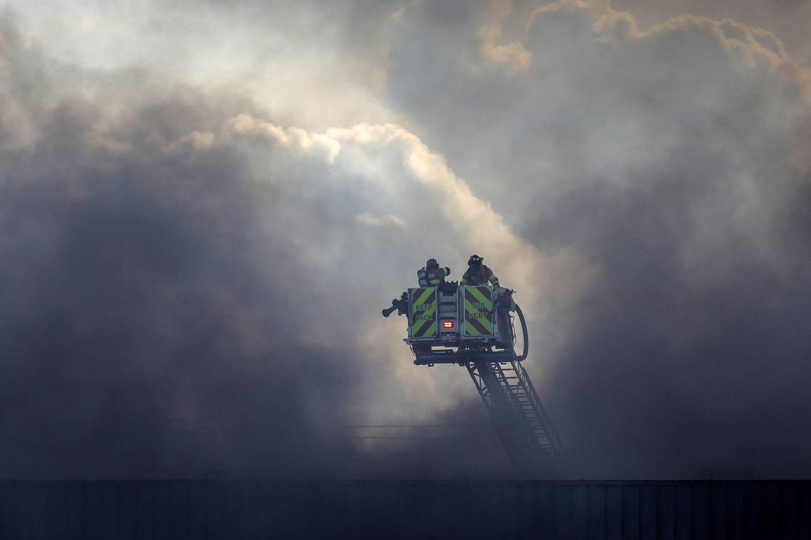 Miami-Dade firefighters battle a large fire at a flea market on Thursday.