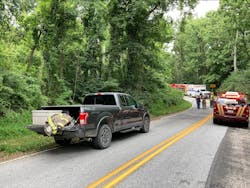 Fire and EMS vehicles line the rural road leading to the crash scene at a campground in York County, PA.