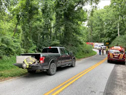 Fire and EMS vehicles line the rural road leading to the crash scene at a campground in York County, PA.