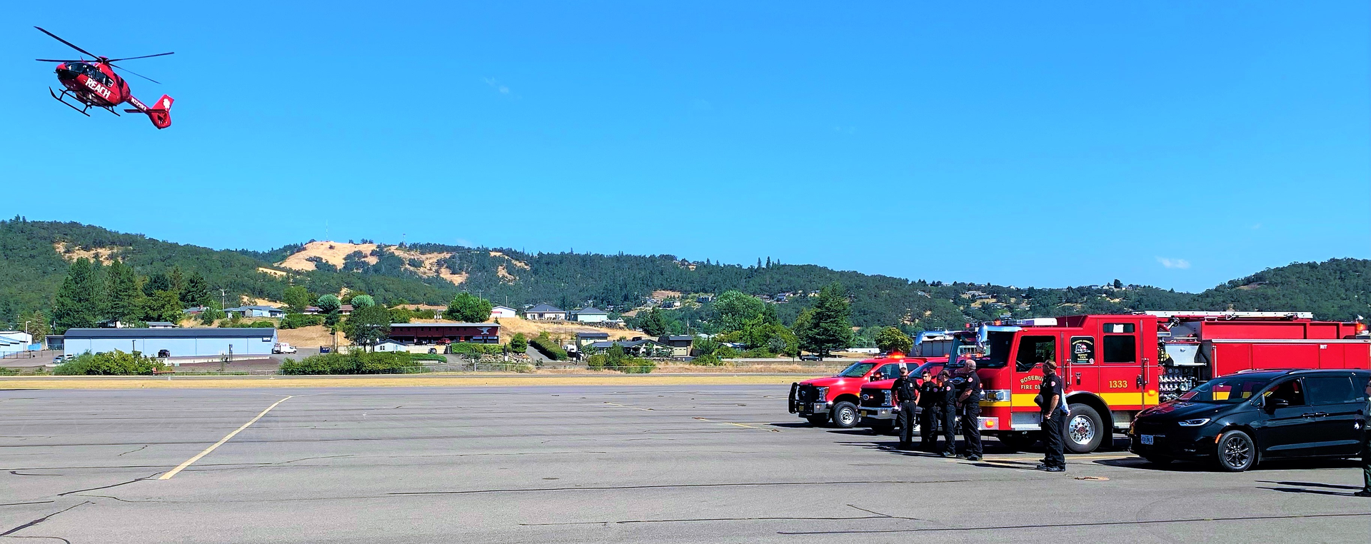 Firefighters await the arrival of the body of a hotshot who was killed Wednesday when he was hit by a tree.