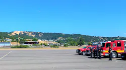 Firefighters await the arrival of the body of a hotshot who was killed Wednesday when he was hit by a tree.