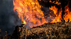 Logan Powell, with a Cal Fire crew from the Amador-El Dorado unit, keeps an eye on hot spots as the Mosquito Fire makes its way up a hill south of Wortons Market in Foresthill on Tuesday, Sept. 13, 2022.