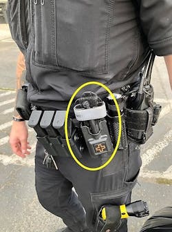 This officer carries their tourniquet in a location just in front of their weapon. Firefighters should be familiar with the identifying marks on the tourniquet case as the tourniquet case could be easily confused with the other equipment pouches carried by the officer. This officer carries their tourniquet in a location just in front of their weapon. Firefighters should be familiar with the identifying marks on the tourniquet case as the tourniquet case could be easily confused with the other equipment pouches carried by the officer.