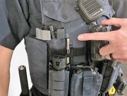 This officer carries their tourniquet in an unmarked pouch near their arm. Located amongst other equipment on the tactical vest, there may be a slight delay in locating this tourniquet in an emergency. This officer carries their tourniquet in an unmarked pouch near their arm. Located amongst other equipment on the tactical vest, there may be a slight delay in locating this tourniquet in an emergency.