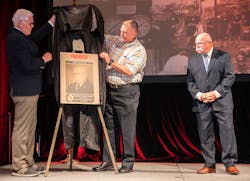 Dr. Denis Onieal (l.) was joined on stage by Firehouse Hall of Famer John J. Salka, Jr. (c.) and together they unveiled Butch Cobb&rsquo;s Hall of Fame plaque.