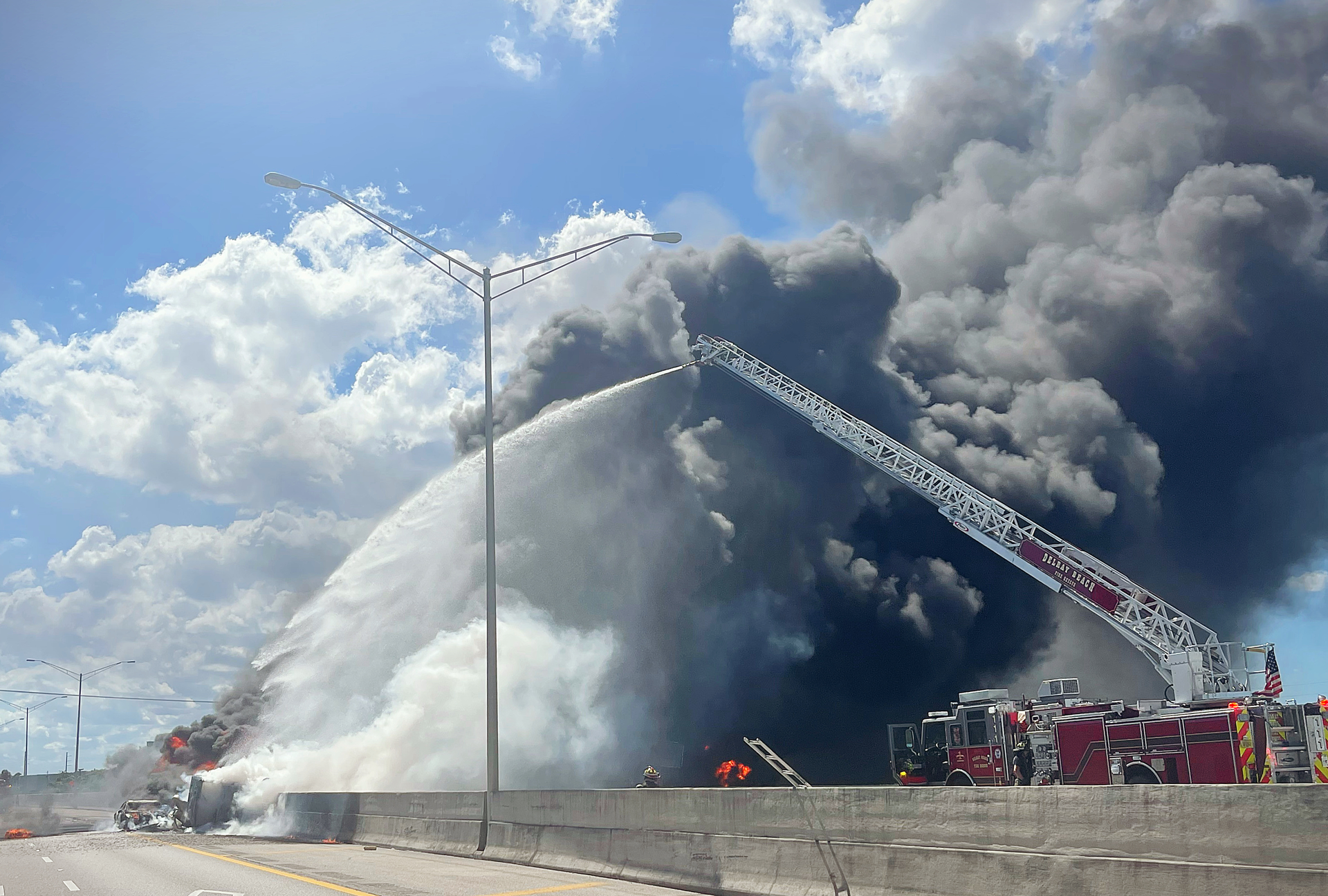 A firefighter forced his way back into the burning car to save his girlfriend.