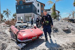 A task force member walks amid debris. A task force member walks amid debris.