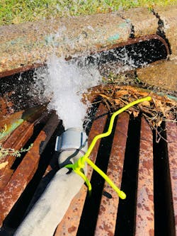 A dump line secured to a sewer grate using a long reusable rubber coated flexible tie. A dump line secured to a sewer grate using a long reusable rubber coated flexible tie.